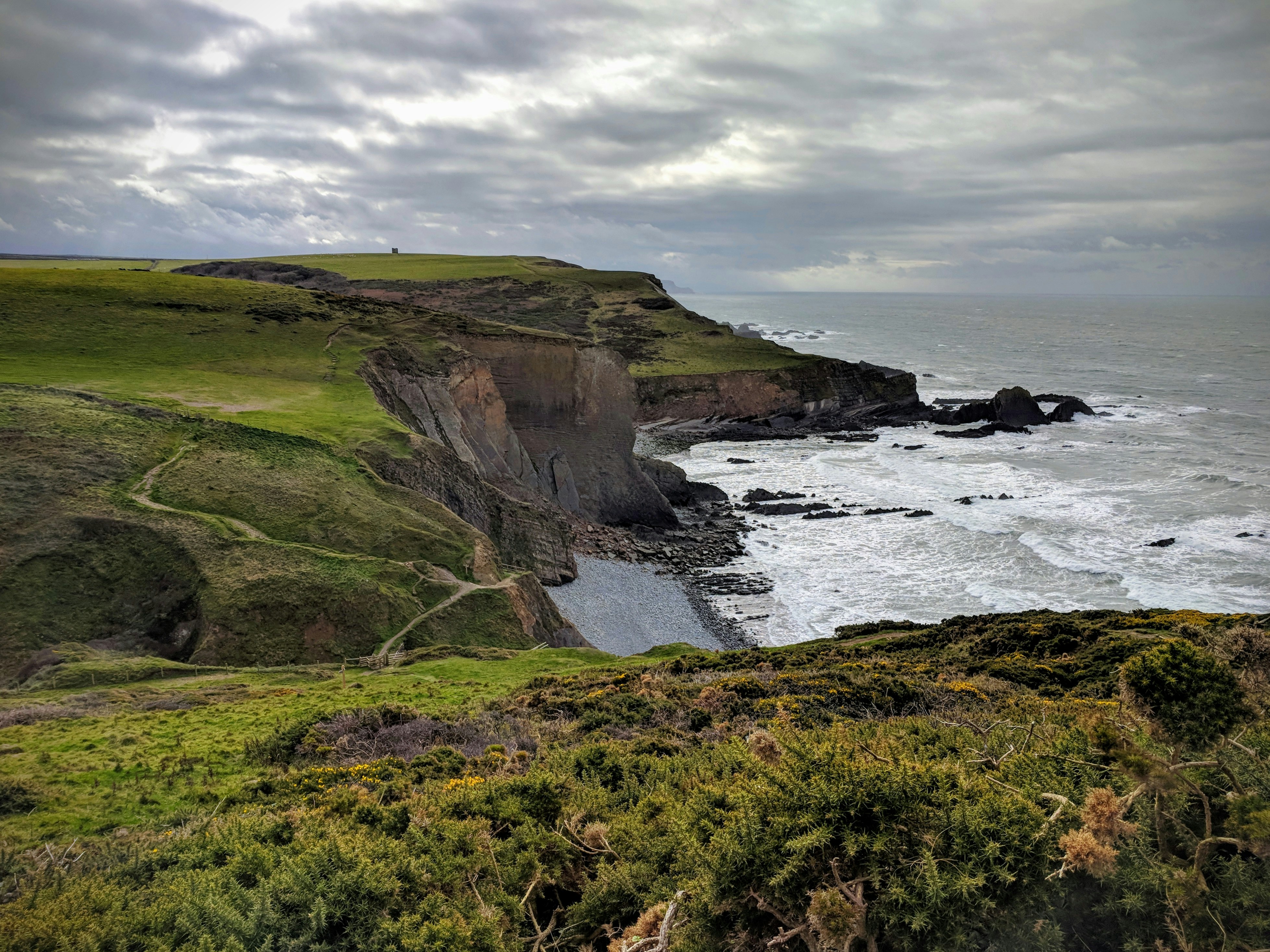 A walker on the South West Coast Path near Hartland
