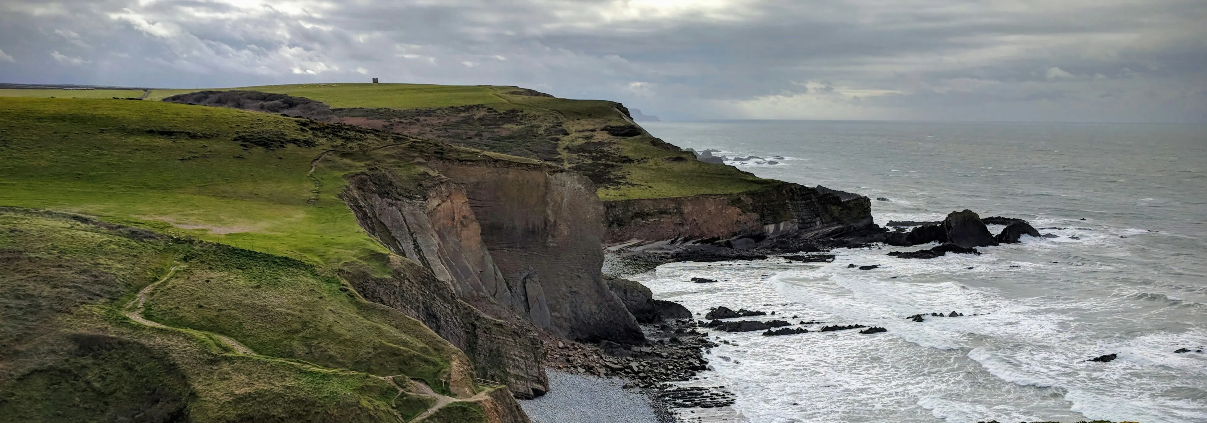 A walker on the South West Coast Path near Hartland